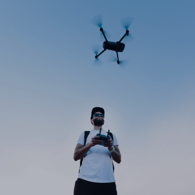 Operator drona trzymający kontroler podczas lotu – ubezpieczenie OC operatora drona
